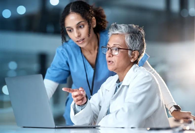 healthcare management professionals smiling because they’re effectively handling generational differences in the workplace
