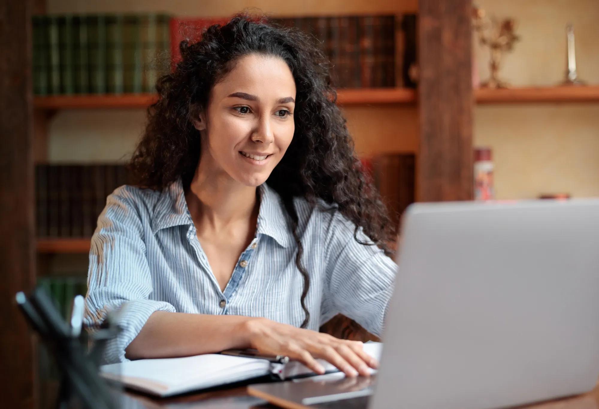 An adult learner studying from home on a laptop.