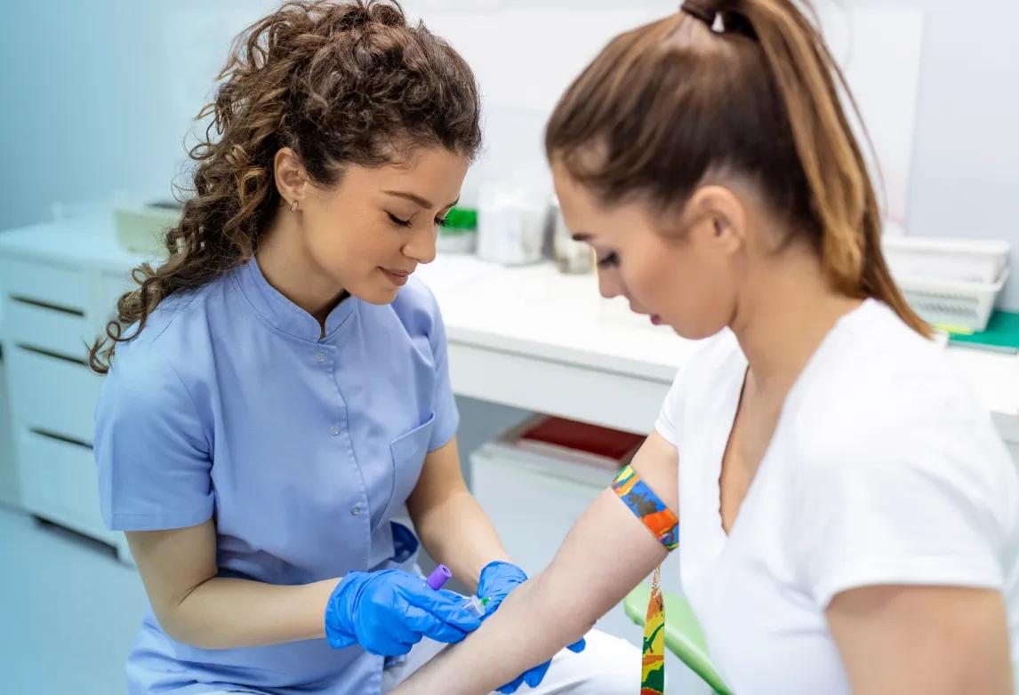 a phlebotomy technician student practicing blood draw preparation as part of a pharmacy technician training program