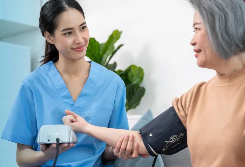 a medical assistant with a patient after completing medical assistant training