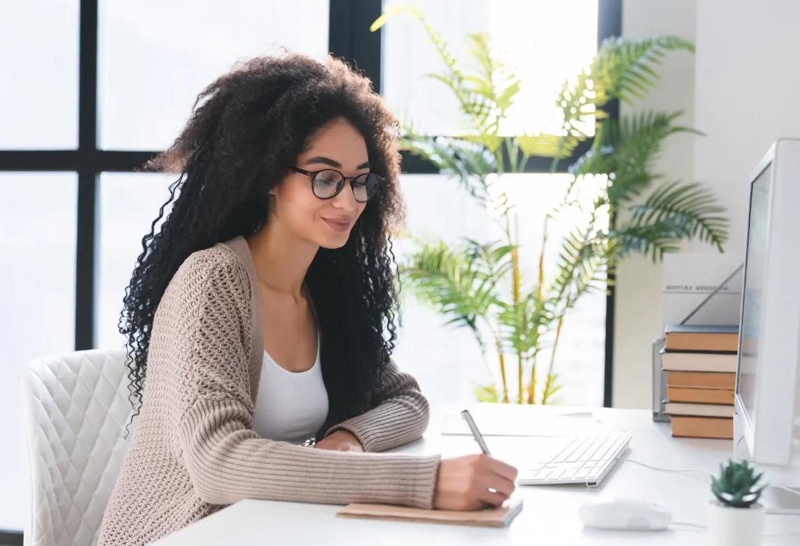 health information management students sitting in a classroom and listening to a HIM degree program instructor
