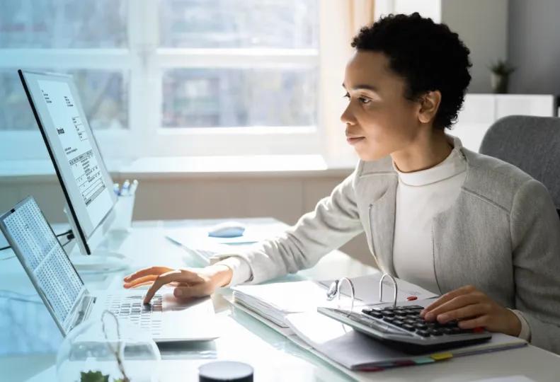 a medical coder working on a computer after completing a medical billing and coding program
