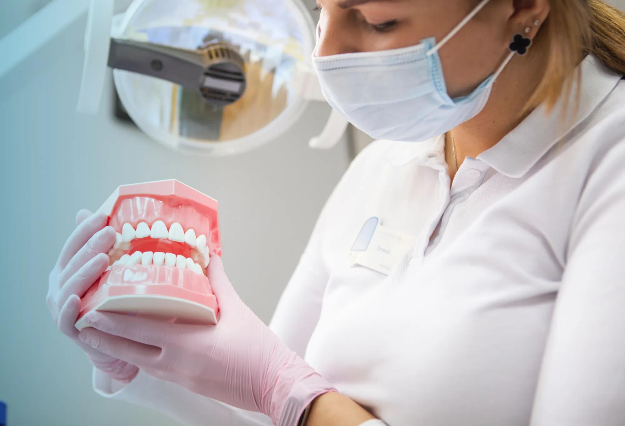 An adult learner engaged in dental assistant training