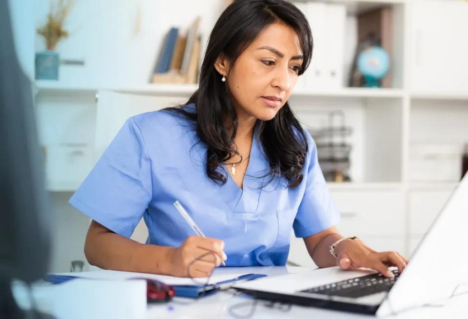 a medical biller and coder working in a healthcare office after completing a medical billing and coding program