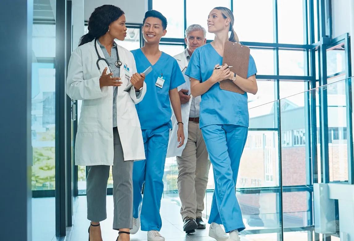 healthcare professionals standing together while problem-solving