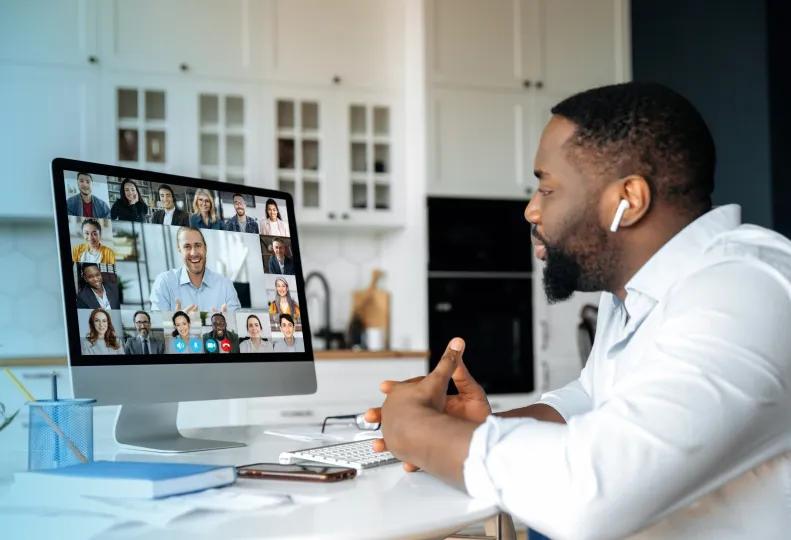 a healthcare professional with flexible work arrangements in a video group meeting while working from home