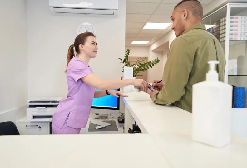 a medical administrative assistant working in a healthcare office after completing online medical administrative assistant training