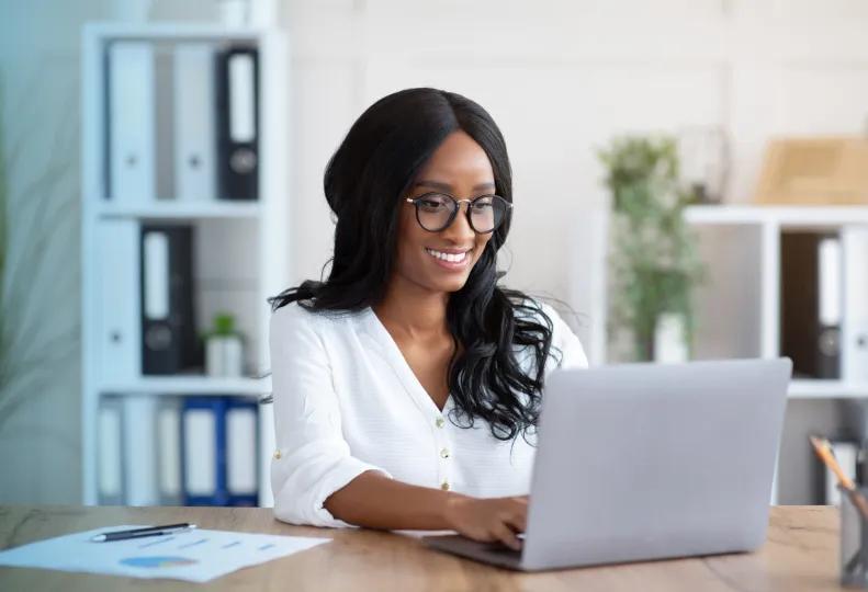 a person researching online degree programs on a laptop computer