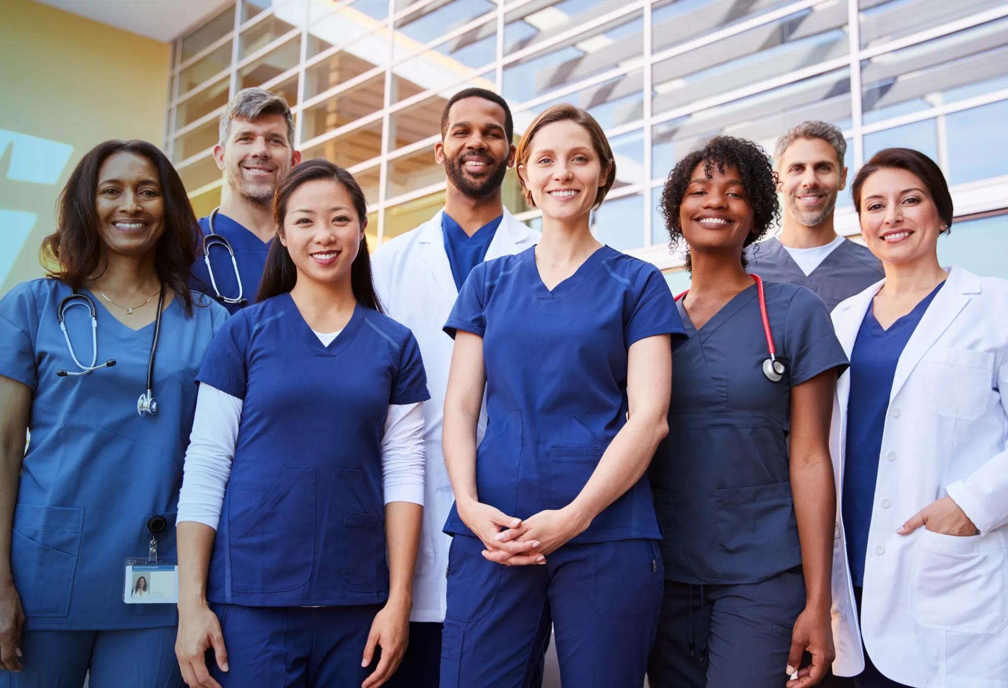 A group of allied health professionals standing together and smiling