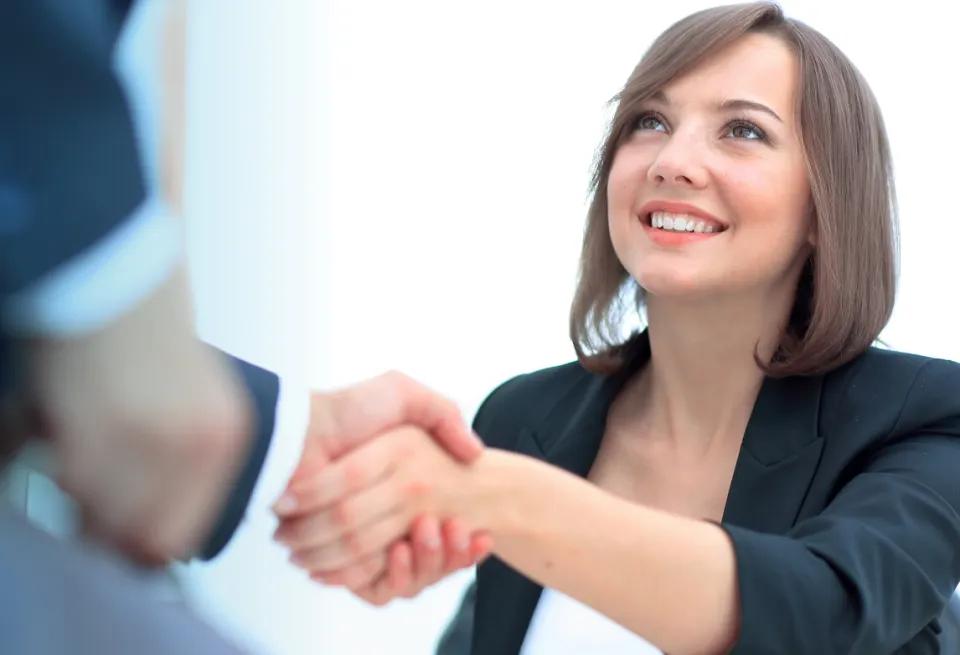 Allied health candidate shaking hands with a prospective healthcare employer.