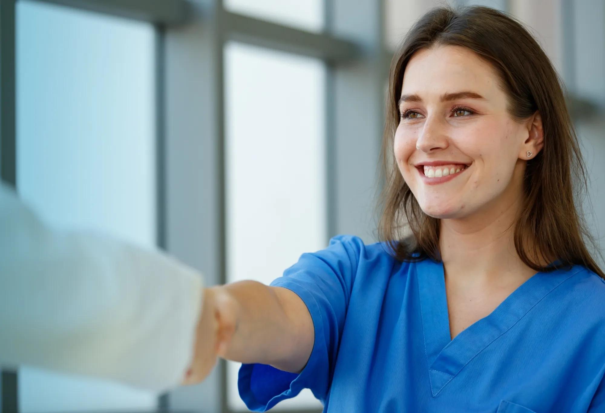 An interview candidate completes the interview process with a handshake.